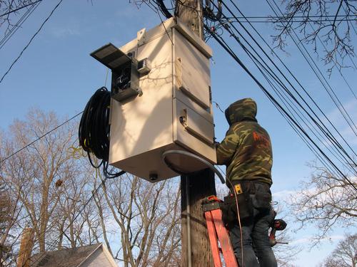 A LightSpeed technician installs a fiber distribution hub on a Lansing street. Each hub is capable of serving fiber to more than 400 homes.