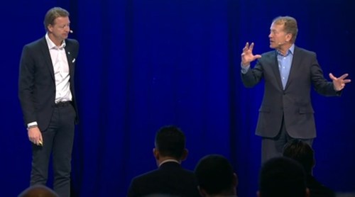 Ericsson CEO Hans Vestberg (left) listens intently while Cisco Executive Chairman John Chambers gesticulates.