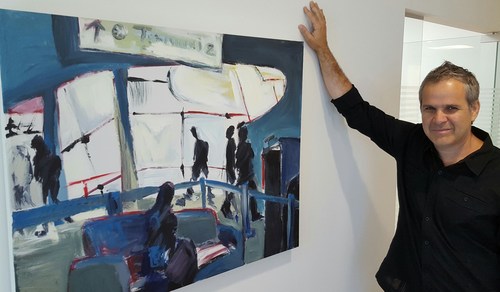 Sedona Systems CTO Ori Gerstel with one of his paintings that adorn the walls at the Tel Aviv offices.