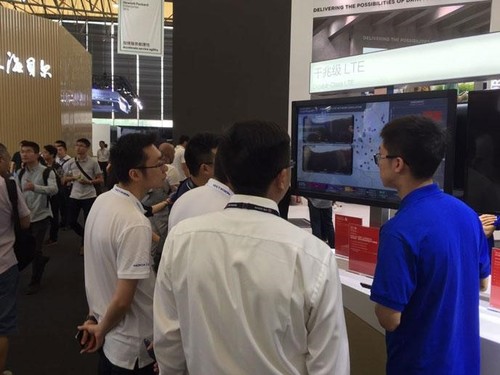 Qualcomm booth visitors observing our TDD Gigabit LTE network simulation.