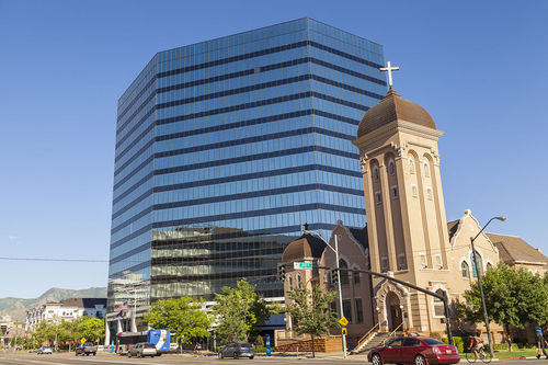 CenturyLink's modern building in Salt Lake City alongside historic church