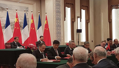 Emmanuel Macron, France's president, sits next to Xi Jinping, his counterpart in China, during the recent signing of an agreement between Sigfox and Chinese telecare company Senioradom.