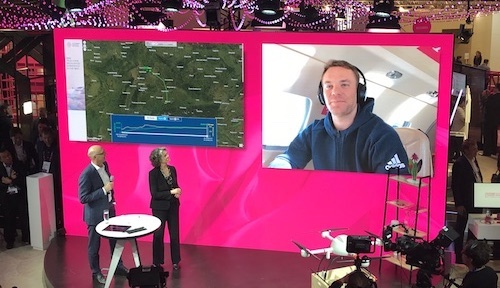 German goalkeeper Manuel Neuer proves a safe pair of hands for Timotheus Hottges, Deutsche Telekom's CEO, and Claudia Nemat, its board member for technology, during an MWC demonstration of the operator's new inflight phone service.