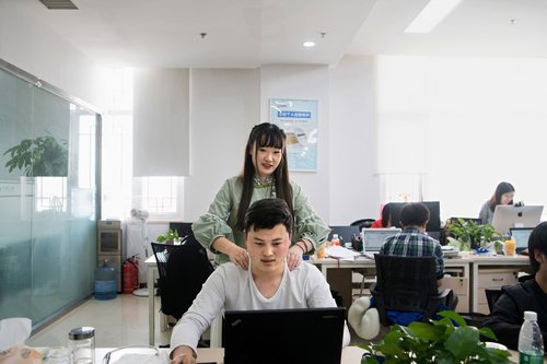 'Shen Yue, who has a degree in civil engineering, giving a colleague a massage in her role as a 'programmer motivator' at Chainfin.com in Beijing,' an article in The New York Times states.