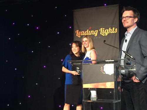 AT&T's Anne Chow receives her award for Most Inspiring Woman of the Year from WiC Director Sarah Thomas, while Light Reading's Phil Harvey basks in the inspiring glow.