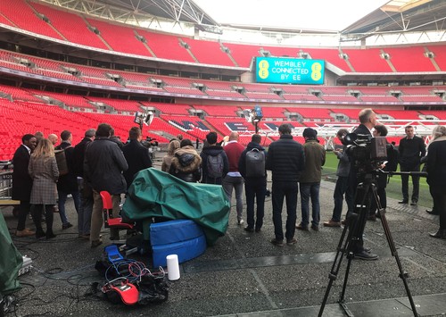 Reporters and analysts gather round for BT's 5G display (the white cylinder in the foreground is the Huawei device that provides connectivity to the stadium antenna).