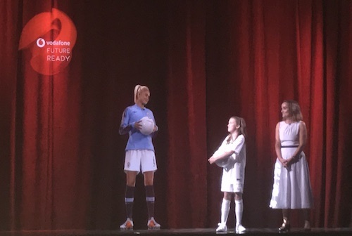 A holographic image of England soccer captain Steph Houghton chats to a young sports fan at Vodafone's Newbury headquarters.
