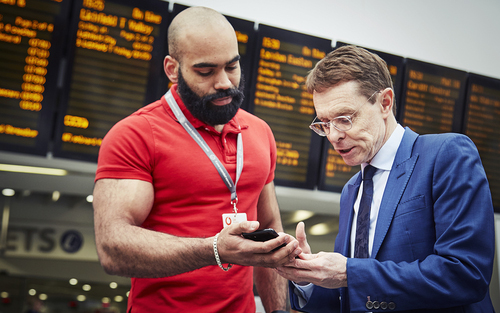 Extravagantly muscled Vodafone operative runs Andy Street, the Mayor of the West Midlands, through the benefits of 5G at Birmingham New Street Station.