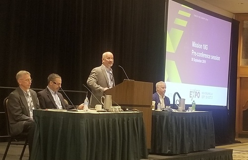SCTE's Chris Bastian (at the lectern) welcomes the crowd to a pre-conference session on 10G. Joining him (left to right) are Tom Cloonan, CommScope; Bob Ferriera, Intel; and Brian Scriber, CableLabs.