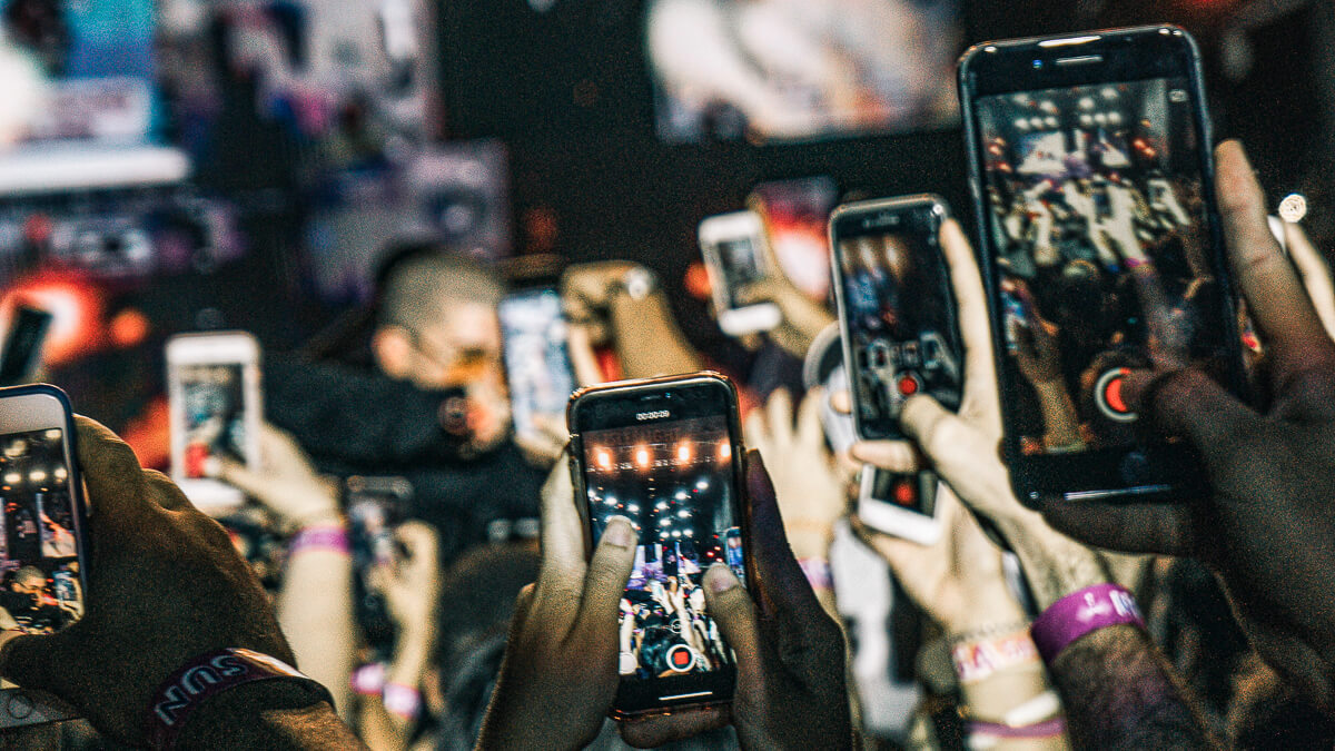 All change: In the same we way no longer crowd together at concerts, the mobile phone market has also changed thanks to COVID-19. (Source: Gian Cescon on Unsplash)