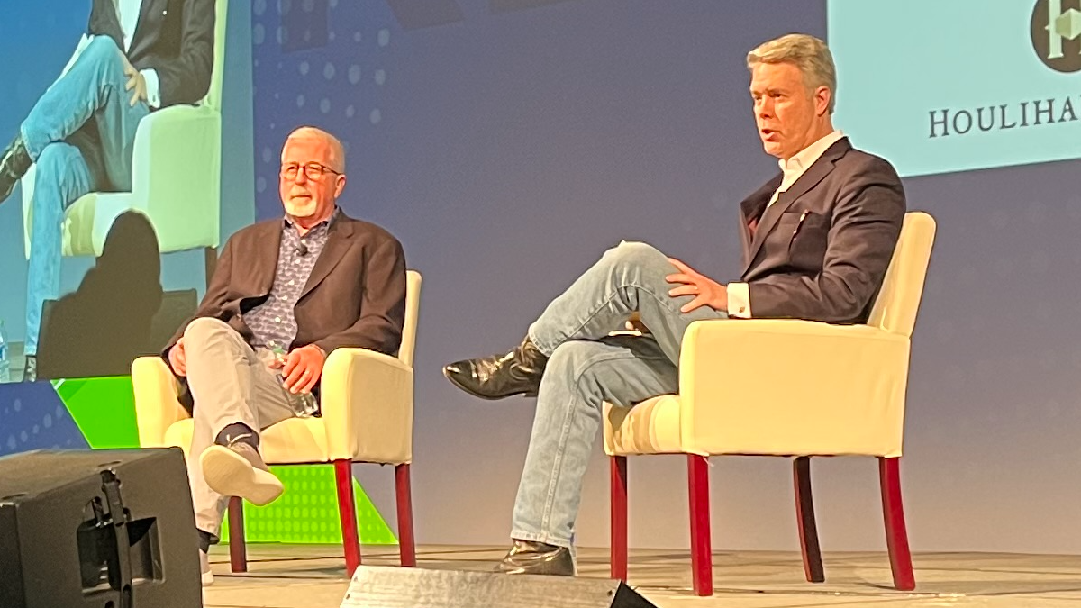 Mayo, left, speaks with Rob McDowell, of law firm Cooley, during a keynote session at the Connect (X) trade show.
(Source: Mike Dano, Light Reading)