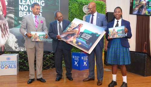 Safaricom Chairman, Nicholas Nganga (center left) and Safaricom CEO Bob Collymore (center right) mark the launch of the Safaricom Sustainability Report 2017 at the company's headquarters. Looking on is UN Resident Coordinator and UNDP Resident Representative, Siddharth Chatterjee (far left) and Ivy Waikwa, a student at the Mpesa Foundation Academy (far right).