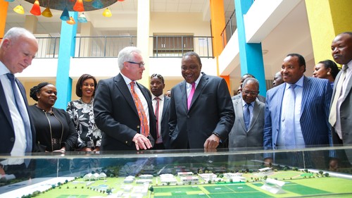 Les Baillie (second left), CEO at the Safaricom M-PESA Foundation Academy, takes the President, H.E. Hon. Uhuru Kenyatta, through the map of the school. This picture was during the Safaricom MPESA Foundation Launch. 