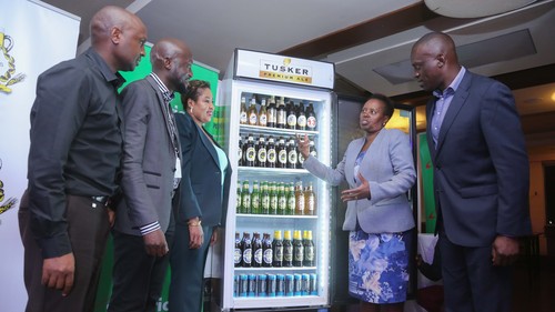 Executives from Safaricom and Kenya Breweries admire one of the IoT connected coolers. 
