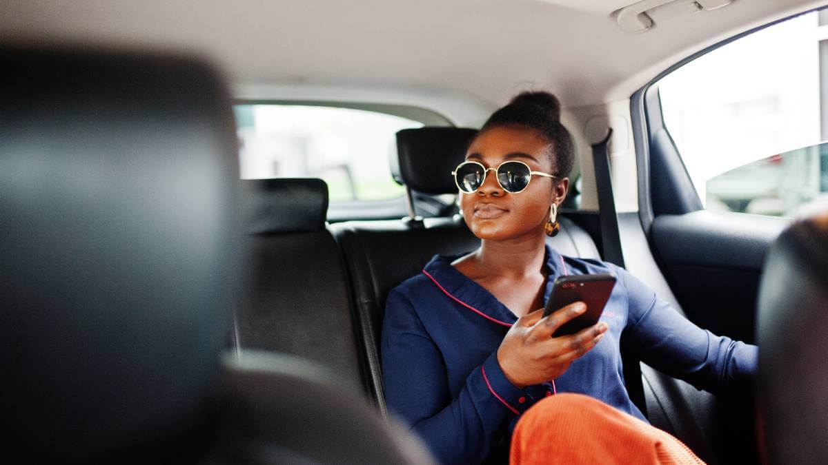 A passenger sits in the back of a car operated by an e-hailing company.  (Source: Image by ASphotofamily on Freepik.)