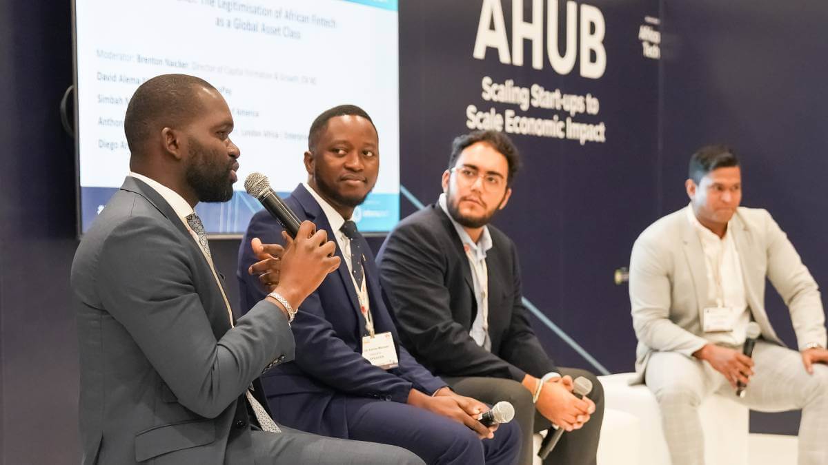 Simbah Mutasa, South Africa MD for Bank of America, speaks during a startup-centric panel discussion as part of the AHUB track at Africa Tech Festival 2022 while David Alema-Mensah, founder of AsaanaPay; Diego Arias, investment associate at Plug and Play; and Brenton Naicker, director of capital formation and growth at CV VC, look on. (Source: Africa Tech Festival).  