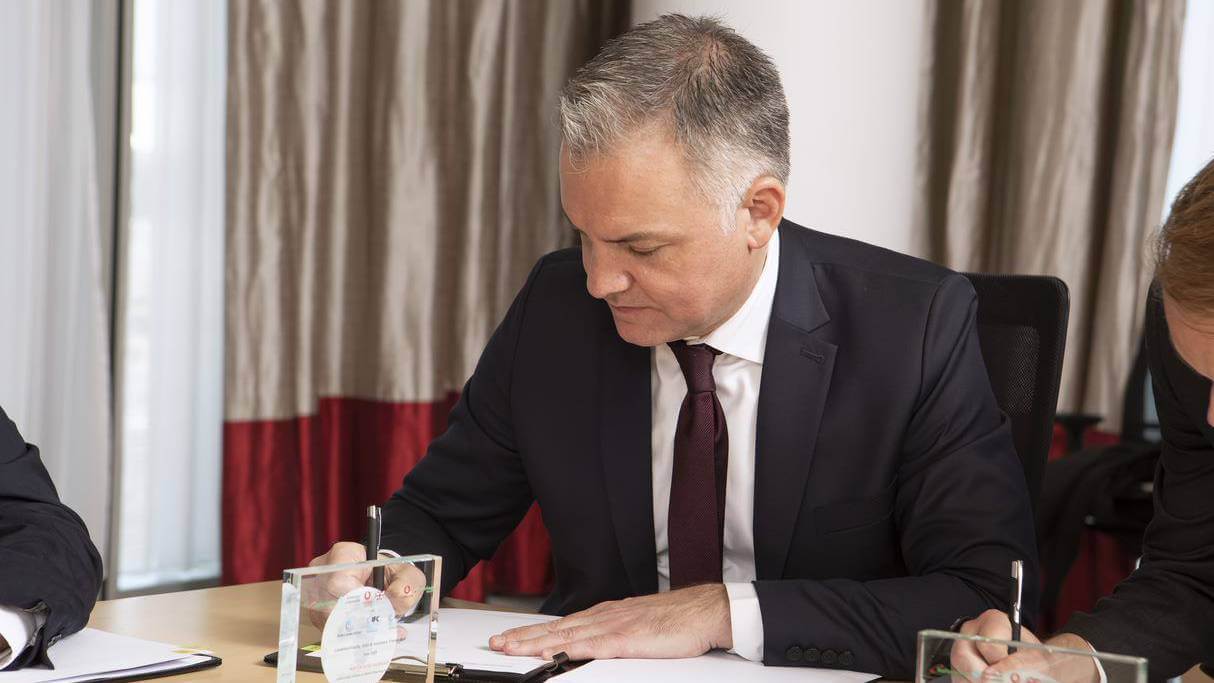 Safaricom Ethiopia CEO Anwar Soussa signs paperwork as part of the IFC's investment into the Global Partnership for Ethiopia's consortium.   (Source: Safaricom Ethiopia)