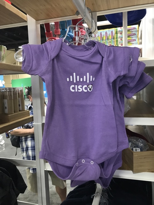 The company store on the show floor sold logo gear, including shirts, jackets, hats -- and this baby onesie. On seeing it, I died from the cute.